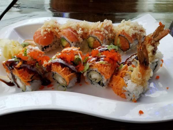 Mets Roll · Spicy salmon and avocado topped with salmon, tempura flake and spicy mayo.