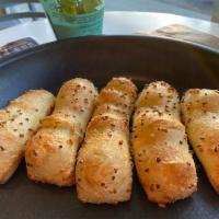 Burnt Garlic Bread Sticks  · Our house specialty, crisp chunks of burnt garlic over fluffy garlic bread sticks with our s...