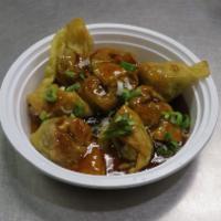 Pan Fried Wonton w. Oyster Sauce · Chinese dumpling that comes with filling.