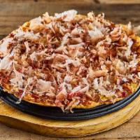 Shrimp Okonomiyaki · Pan fried flour, shrimp, cabbage, egg yolk, bacon with katsu sauce, mayo, bonito flakes on t...