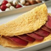 Pastrami and Cheddar Cheese Omelette · Fresh eggs, pastrami, and cheddar cheese omelet served with home fries.