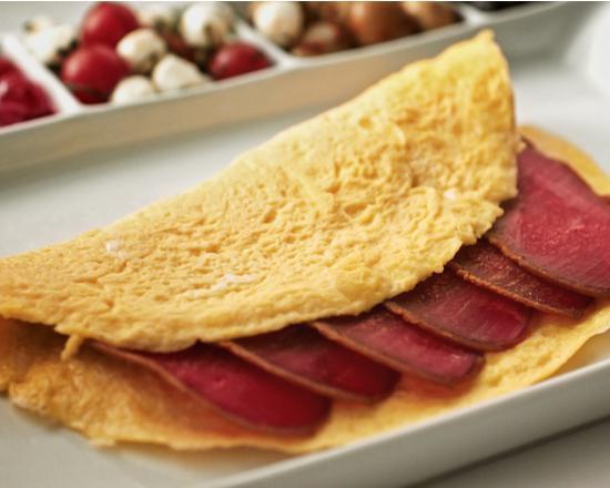 Pastrami and Cheddar Cheese Omelette · Fresh eggs, pastrami, and cheddar cheese omelet served with home fries.