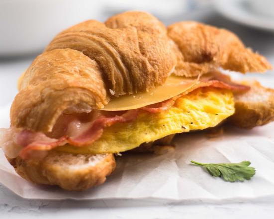Croissant with Bacon, Egg, and Cheese · Buttery and flakey croissant filled with fresh eggs, crispy bacon, and melted cheese.
