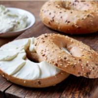 Bagel with Cream Cheese · Fresh baked bagel with a side of cream cheese.