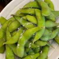 Edamame · Steamed green soybeans served with sea salt.