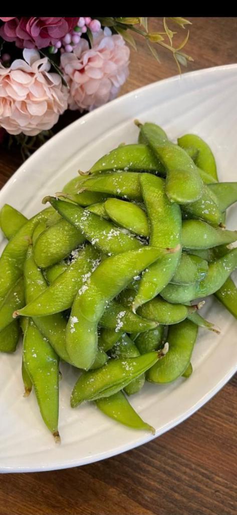 Edamame · Steamed green soybeans served with sea salt.