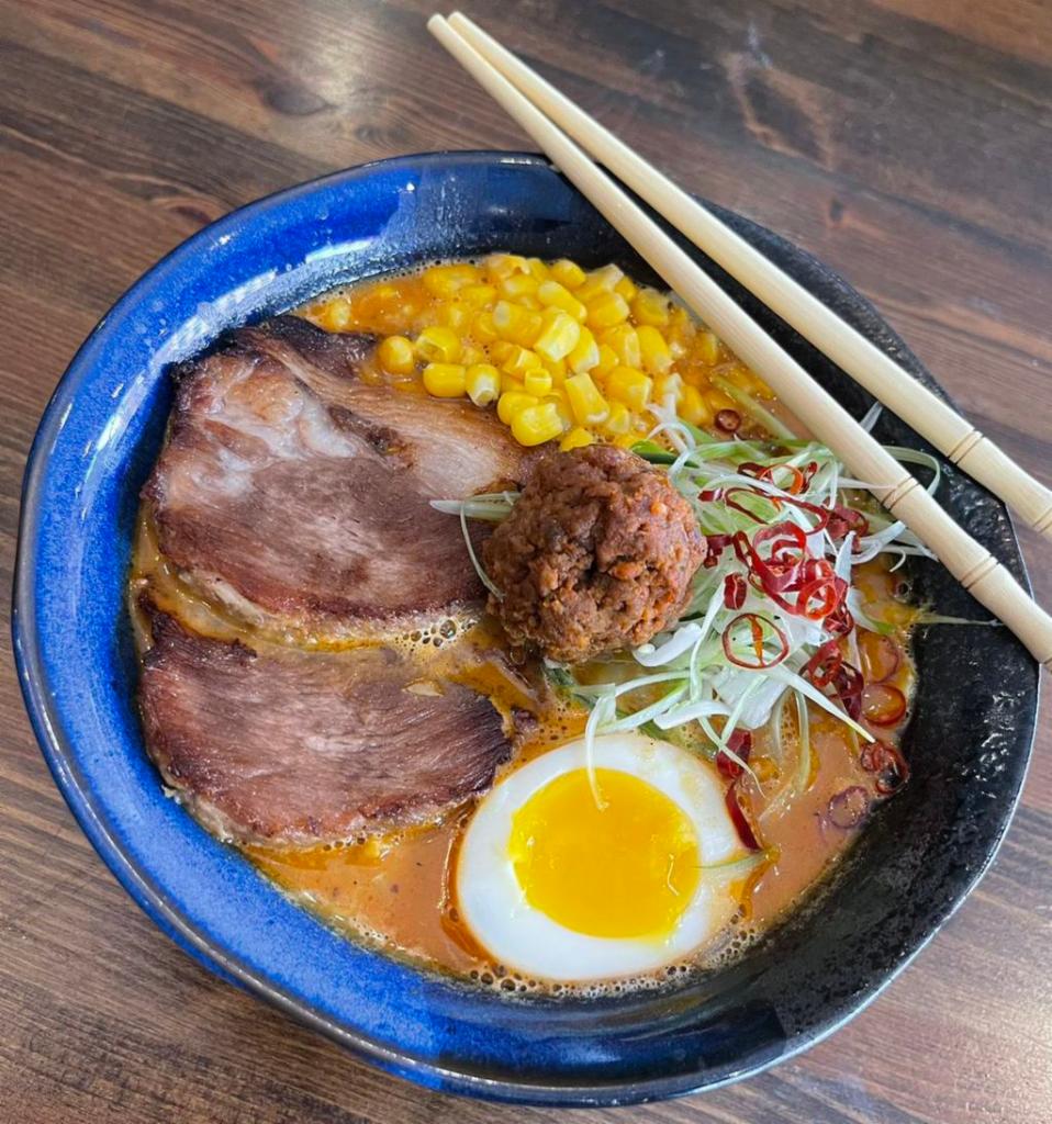 Spicy Miso Ramen · Spicy miso flavored pork bone stock soup with cabbage, sprouts, spicy ground pork, chachu, egg, scallions, and bamboo shoots.