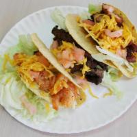 21a. Shrimp Taco · Fried corn tortilla served with iceberg lettuce, tomato and topped with cheddar cheese. 
