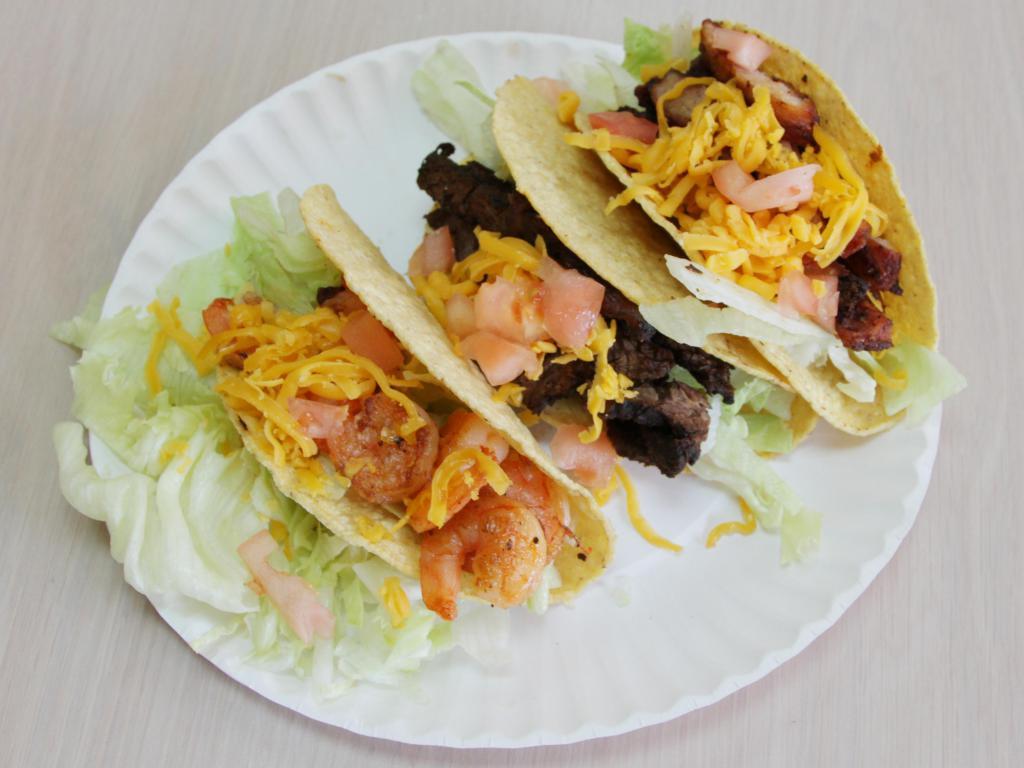 21a. Shrimp Taco · Fried corn tortilla served with iceberg lettuce, tomato and topped with cheddar cheese. 