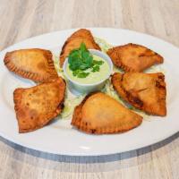 Empanadas · 5 pieces. Freshly made pastry stuffed with your choice of chicken or beef, served with cilan...