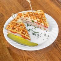 The Tables Best Turkey Sandwich · Heavenly waffle, turkey, Swiss cheese, tomatoes, basil, and a honey mustard aioli. Served wi...
