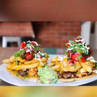 Tacos Locos · 2 tacos made with Chicken & steak with cheese fries, pico de gallo, fresh cream and green sa...