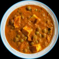 26. Matar Paneer · Cheese cooked with peas, onion and tomato sauce. 