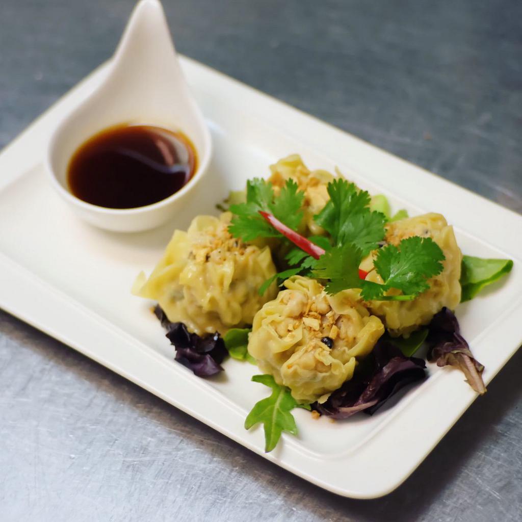 Steamed Chicken dumpling · Steamed chicken with water chestnut, scallion, cilantro , shintake mushroom, tapioca flour, served with vinaigrette sauce