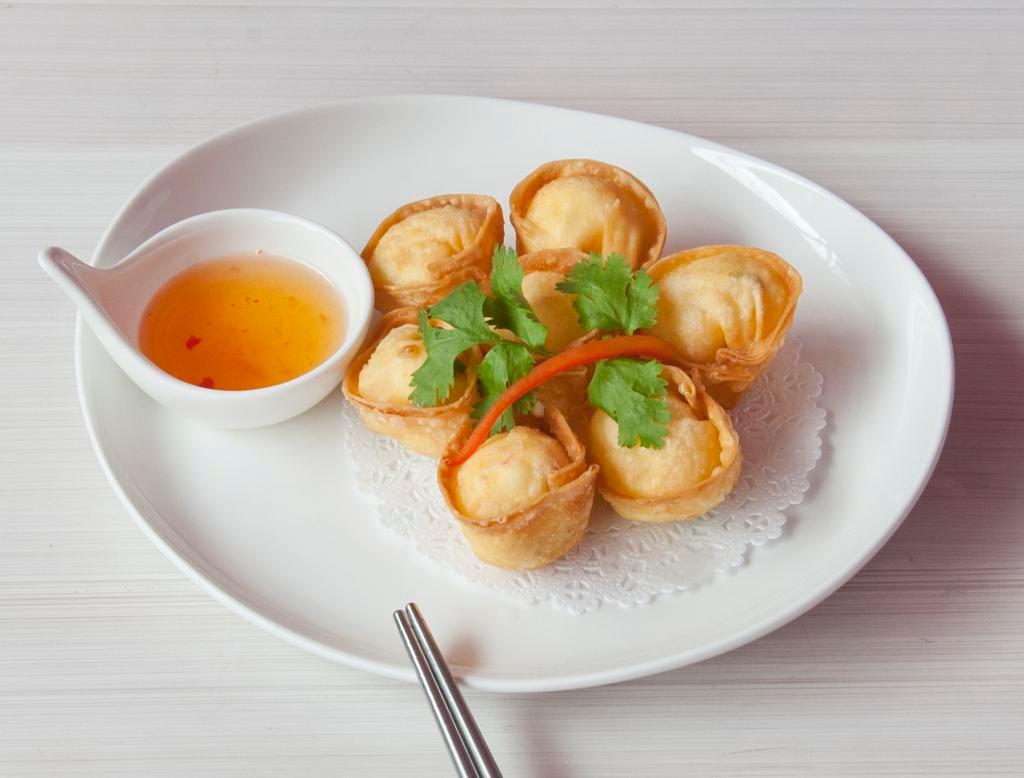 Stuffed Crab Rangoon · Homemade wonton filled with cream cheese, crab meat and chopped onion served with sweet chili sauce.