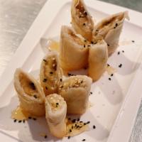 Fried Banana with Honey · Crispy fried Banana wrapped in thin flour skin served with honey and roasted sesame sprinkle