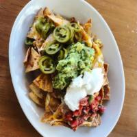 Nachos · Monterey Jack and cheddar cheese, jalapenos, salsa, sour cream and guacamole. Add chicken or...