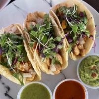 3 Tacos · served in a tortilla with onions, cilantro, lettuce & salsa verde.