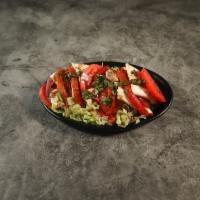 Caprese Salad · Fresh mozzarella, roasted peppers, fresh tomato, basil and homemade balsamic vinegar.
