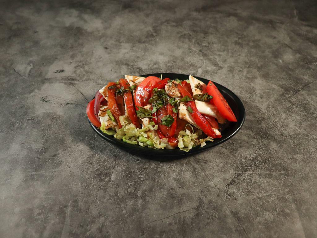 Caprese Salad · Fresh mozzarella, roasted peppers, fresh tomato, basil and homemade balsamic vinegar.