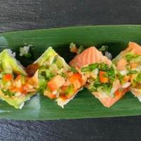 Sunshine Roll · Tempura shrimp, spicy crab. Top: salmon, avocado, thinly sliced lemon, fugu sauce, ponzu sau...