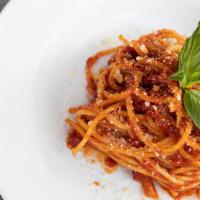 Pasta with Pomodoro e Basilico · Signature tomato sauce and basil.