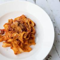 Pasta with Bolognese · Signature tomato sauce with meat.