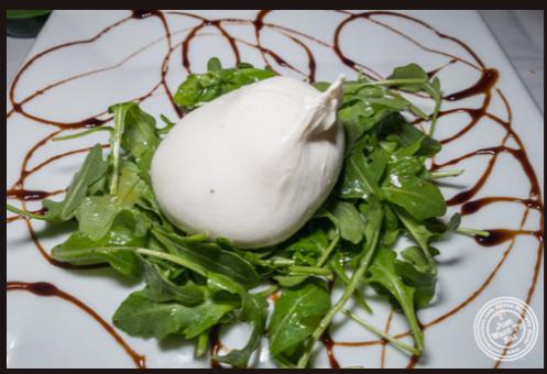 Burrata Tartufo · Creamy Mozzarela Cheese infused in Truffle Oil and served over Baby Arugula with Truffled Balsamic Reduction