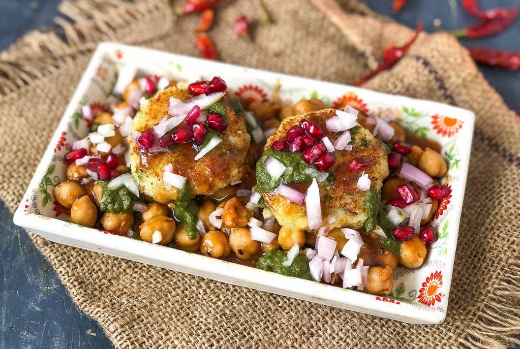 Aloo Tikki Chat · 2 pieces. Potato and green peas cakes served with chickpea, yogurt and tamarind sauces.