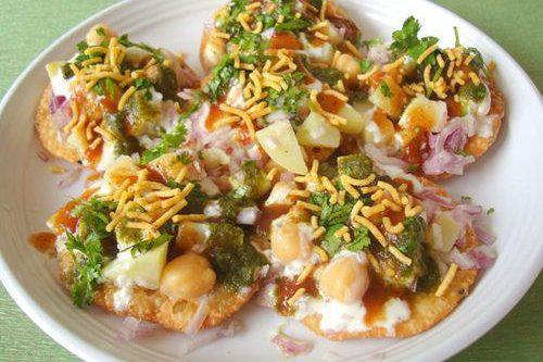 Aloo Papri Chat · Flour crispies topped with potatoes. Chickpea, flour straws and mint, yogurt and tamarind sauces.