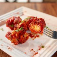 Lasuni Gobi · Crispy cauliflower tossed in a tangy garlic and tomato sauce.