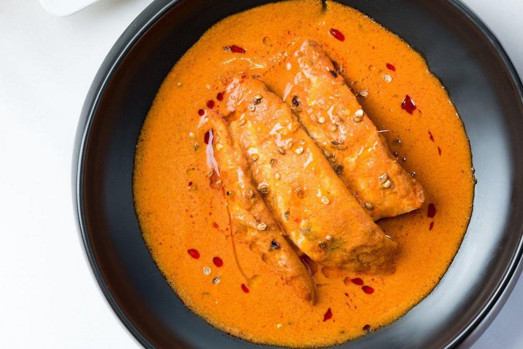 Goan Fish Curry · Let of salmon marinated in tamarind and simmered in a delicately spiced gravy.