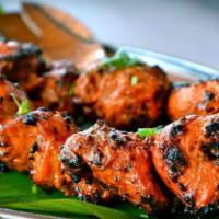 Chicken Tikka Kebab · Cubes of chicken breast marinated in ginger garlic and herbs slowly cooked on skewers in tan...