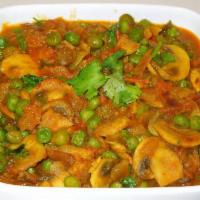 Shabnam Curry · Mushroom and green peas cooked in a tomato and onion gravy.