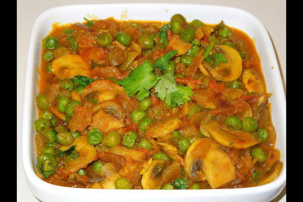 Shabnam Curry · Mushroom and green peas cooked in a tomato and onion gravy.