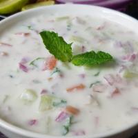 Raita · Homemade yogurt with spices, fresh herbs and cucumber.