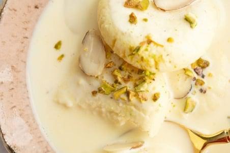 Rasmalai · Spongy Home Made Cheese Patties Simmered In Milk Flavored With Rose Water