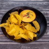 Chile con Queso · Creamy blend of melted cheese and peppers. Gluten free and vegetarian.