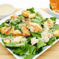 Caesar Salad · Tender grilled chicken, croutons, and Parmesan cheese on a bed of romaine lettuce. Served wi...