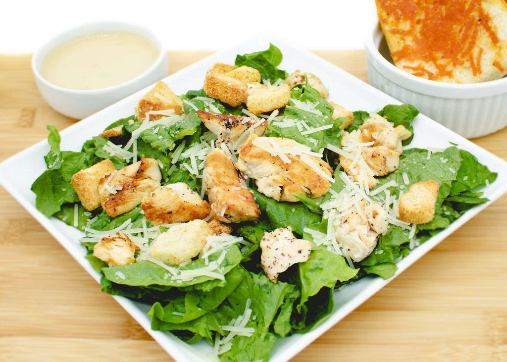 Caesar Salad · Tender grilled chicken, croutons, and Parmesan cheese on a bed of romaine lettuce. Served with a side of buttery, cheesy garlic bread.