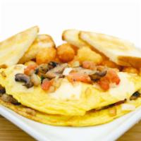 Veggie Omelette · Grilled fresh mushrooms, 2 eggs, tomato, onion, spinach and Swiss cheese. Served with crispy...