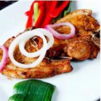 Fried Pork Chops · Served with rice and beans or moro or tostones and a  green salad