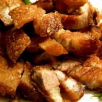 Chicharron (Fried pork) · Served with rice and beans or moro or tostones and a green salad