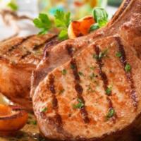 Grilled Pork Chops · 2pork chops served with rice and beans or moro or tostones and a green salad