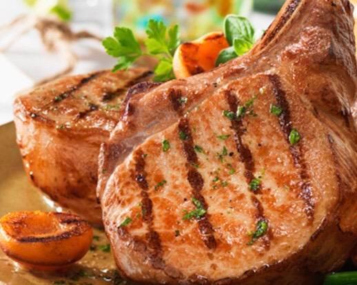 Grilled Pork Chops · 2pork chops served with rice and beans or moro or tostones and a green salad