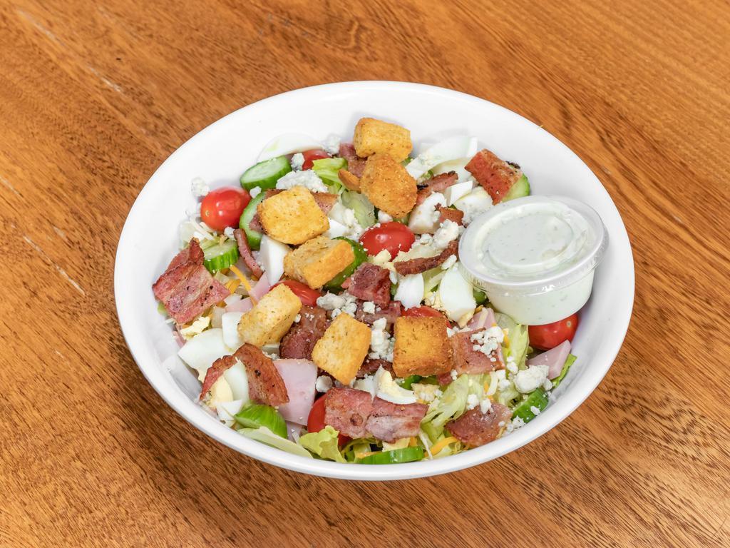 Lemon Drop Cobb Salad · Chopped lettuce, chicken breast, ham, bacon, hard-boiled eggs, tomatoes, cucumbers, shredded cheese, and croutons.