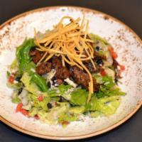 Carne Asada Salad · Fire grilled skirt steak, iceberg lettuce, tomato, avocado, jack cheese, black beans, tortil...