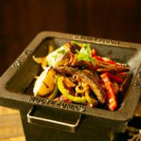 Steak Fajitas · Mixed with onions and bell peppers, served with rice, beans, sour cream, cheese, pico de gal...