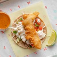 BAJA CRISPY FISH TACO · Crispy Baja Fried Fish. Served on authentically nixtamalized corn tortillas with thinly shre...