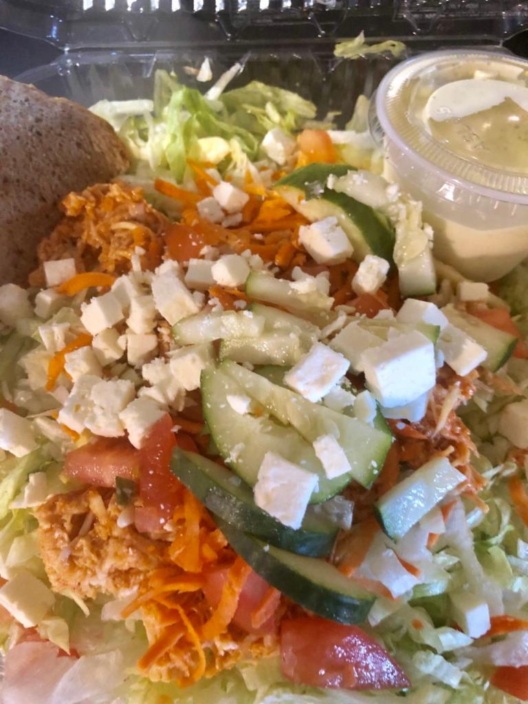 Kickin' Chicken Salad · Spicy hot chicken breast, carrots, cucumber, tomato & cheddar on a bed of lettuce served with ranch dressing & hummus and pita.